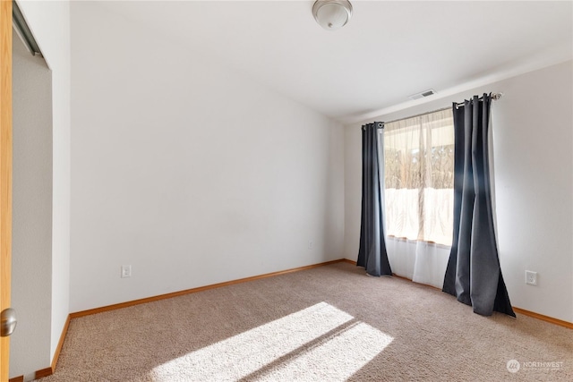 spare room featuring light colored carpet