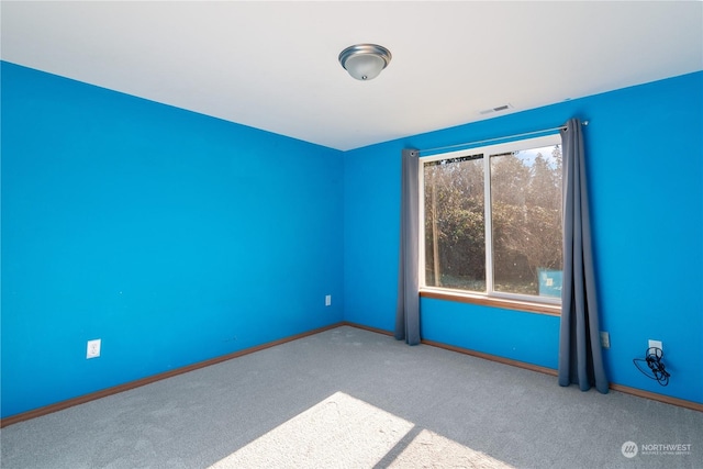 unfurnished room featuring light colored carpet