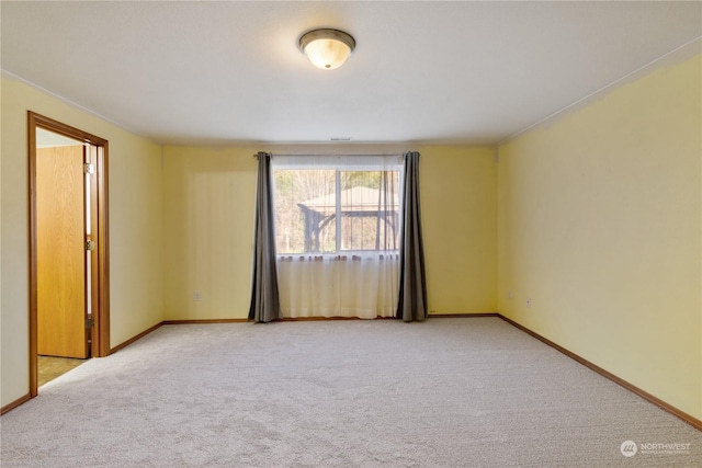 spare room with light colored carpet