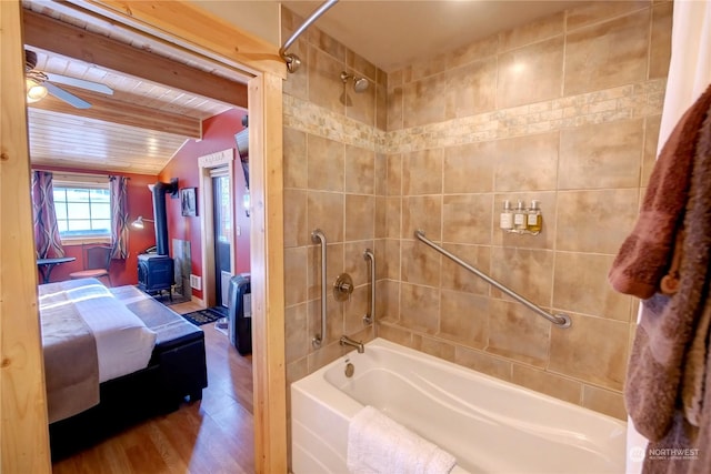 bathroom featuring wood-type flooring, a wood stove, ceiling fan, wooden ceiling, and beam ceiling