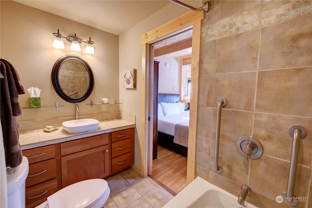 full bathroom with toilet, tile patterned floors, vanity, and bathtub / shower combination