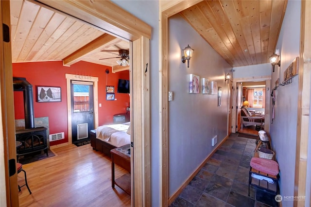 hallway featuring lofted ceiling with beams, wood ceiling, and dark hardwood / wood-style flooring