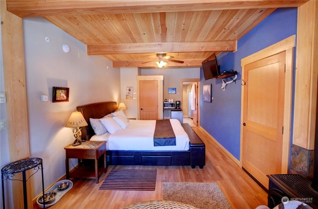 bedroom with beam ceiling, wood ceiling, and light hardwood / wood-style flooring