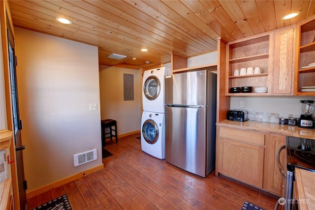 kitchen with appliances with stainless steel finishes, wood ceiling, light hardwood / wood-style floors, stacked washer and clothes dryer, and electric panel