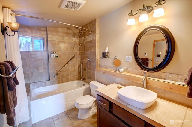 full bathroom featuring tile patterned floors, toilet, vanity, and tiled shower / bath