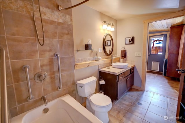 full bathroom featuring toilet, tiled shower / bath combo, tile patterned flooring, and vanity