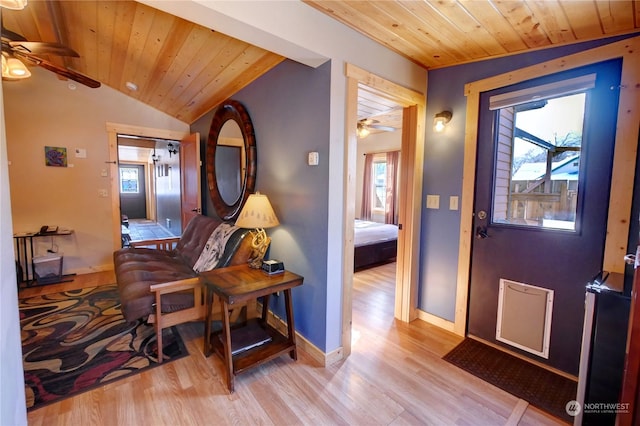 foyer entrance featuring lofted ceiling, ceiling fan, wood ceiling, and light hardwood / wood-style floors