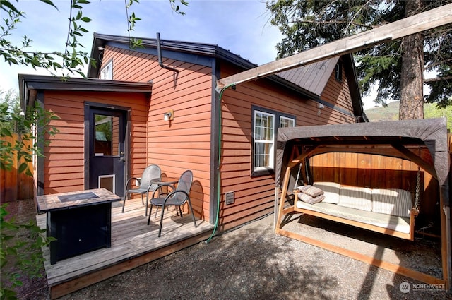 back of house with a wooden deck