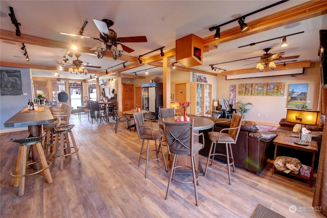 dining room featuring ceiling fan, track lighting, and light hardwood / wood-style floors