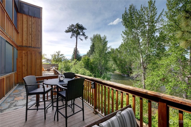 wooden terrace featuring a water view