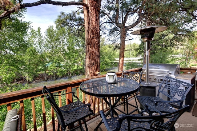 wooden terrace with a grill