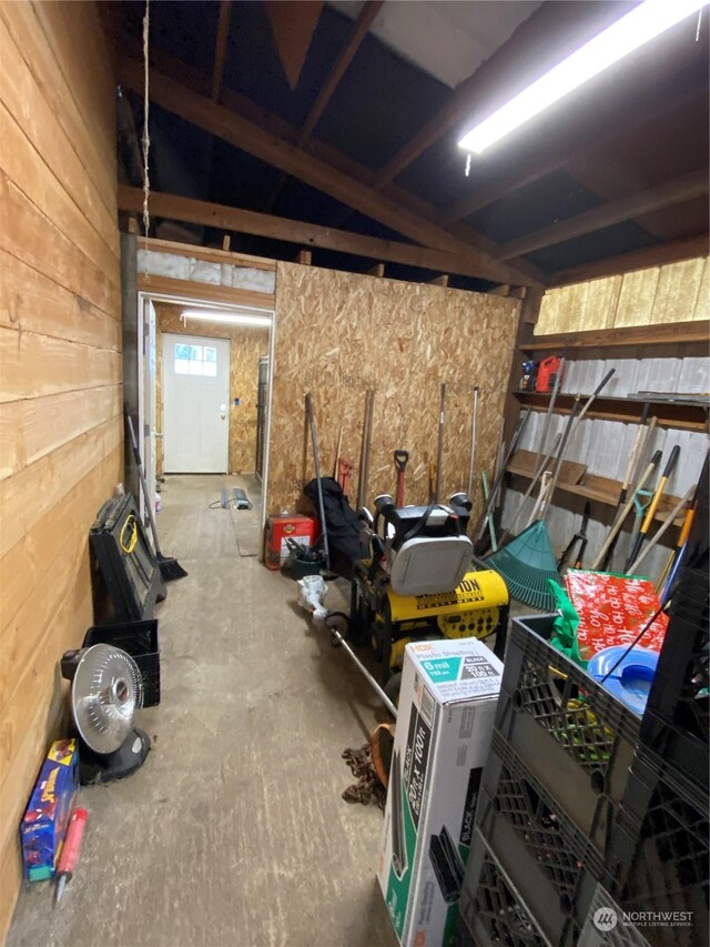 garage featuring wood walls