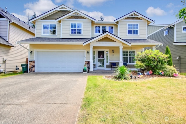 craftsman-style home with a garage, a porch, and a front lawn