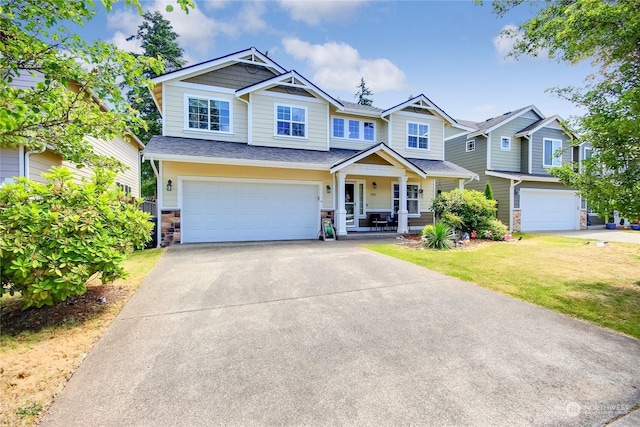 craftsman inspired home featuring a garage, a front yard, and covered porch