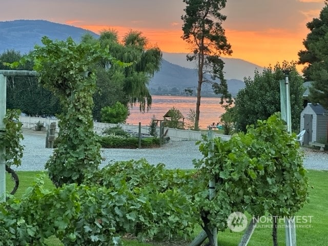 surrounding community featuring a water and mountain view