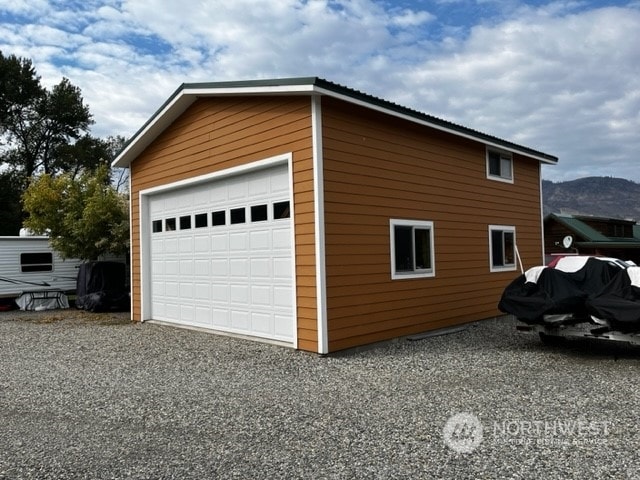 view of side of home with a garage and an outdoor structure