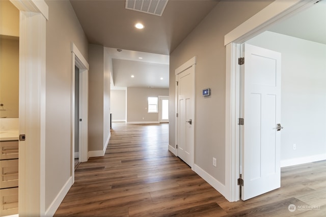 corridor with hardwood / wood-style floors