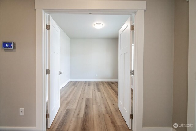 corridor with light wood-type flooring