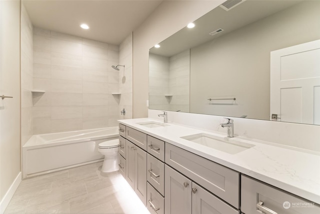 full bathroom featuring vanity, toilet, and tiled shower / bath combo