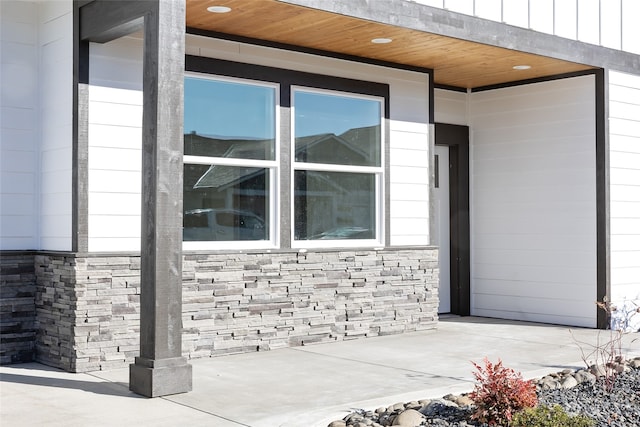 view of home's exterior with stone siding and board and batten siding