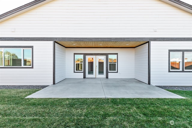 back of house featuring a patio area, a yard, and french doors