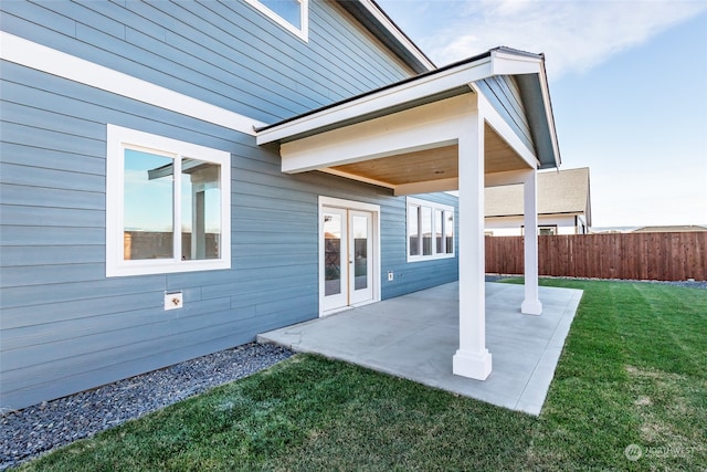 back of property featuring a lawn and a patio area