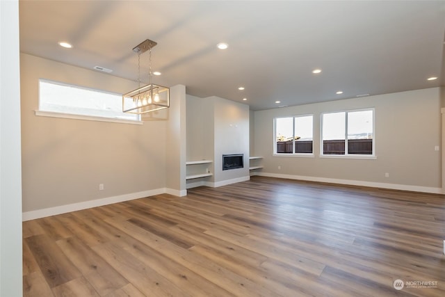 unfurnished living room featuring hardwood / wood-style floors