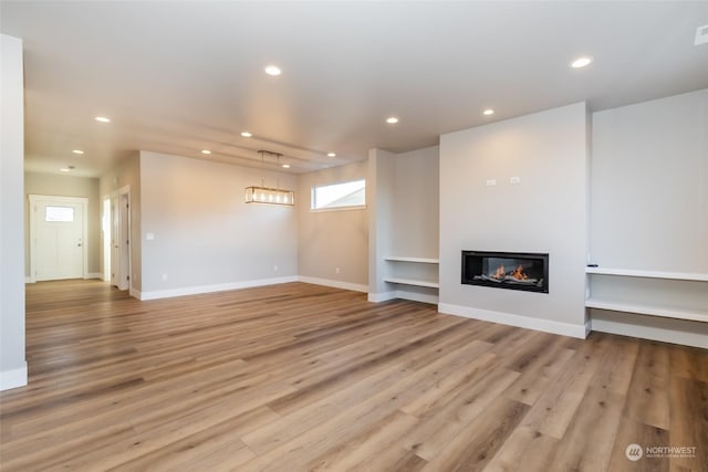 unfurnished living room featuring light hardwood / wood-style flooring