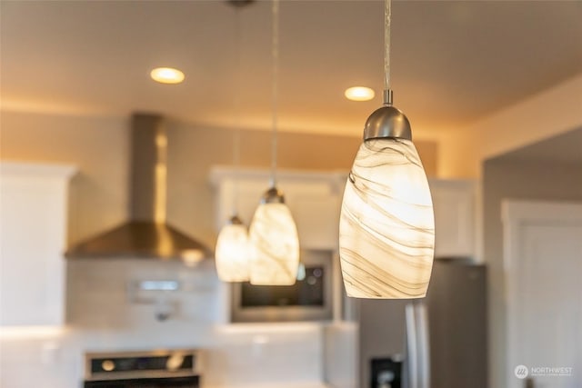 interior details featuring wall chimney range hood