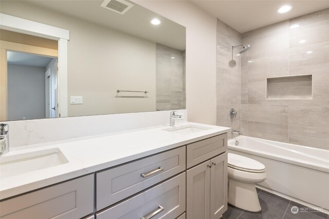 full bathroom with tile patterned floors, vanity, toilet, and tiled shower / bath