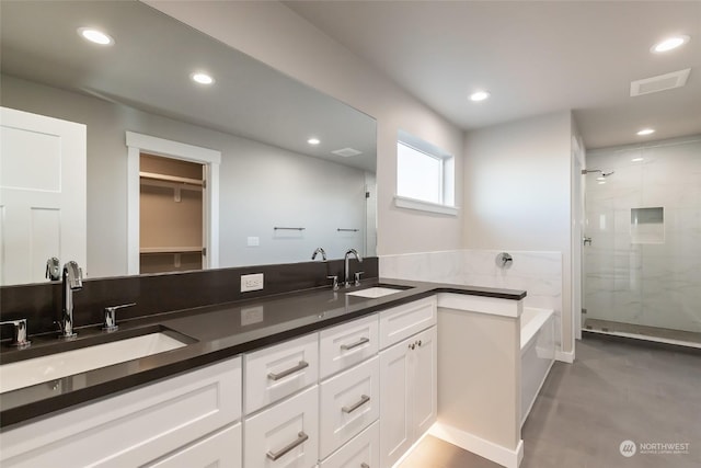 bathroom with vanity, separate shower and tub, and concrete floors