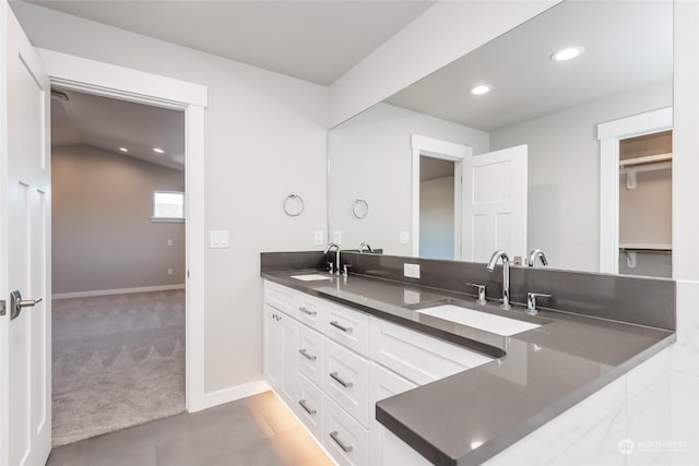 bathroom featuring vanity and lofted ceiling