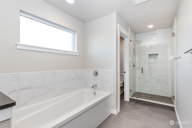 full bathroom featuring tile patterned floors, vanity, independent shower and bath, and toilet