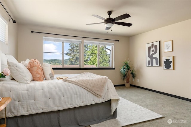 bedroom with carpet, ceiling fan, and baseboards