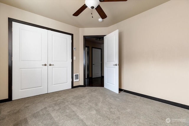 unfurnished bedroom featuring light colored carpet, ceiling fan, and a closet