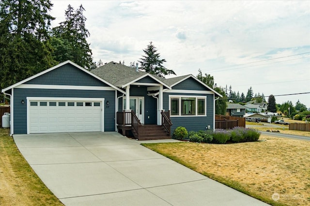 view of front of property with a garage, a front yard, and concrete driveway