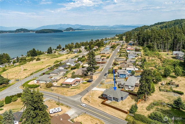 drone / aerial view with a water and mountain view