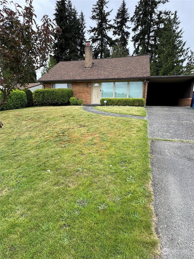 ranch-style house with a front lawn and a carport