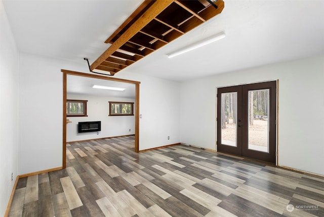 spare room with hardwood / wood-style flooring and french doors