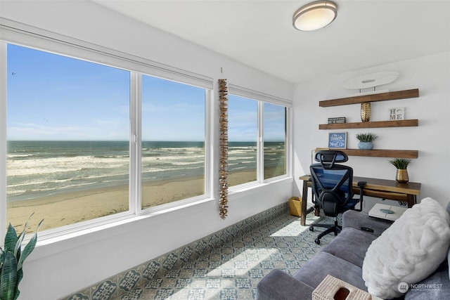 office area with a water view and a view of the beach