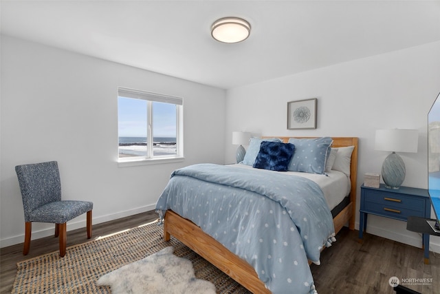 bedroom with dark hardwood / wood-style floors