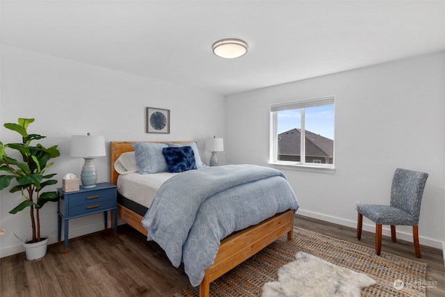 bedroom with dark wood-type flooring