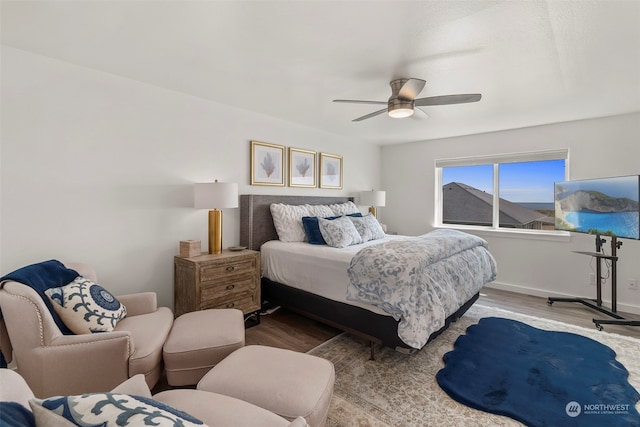 bedroom with hardwood / wood-style flooring and ceiling fan