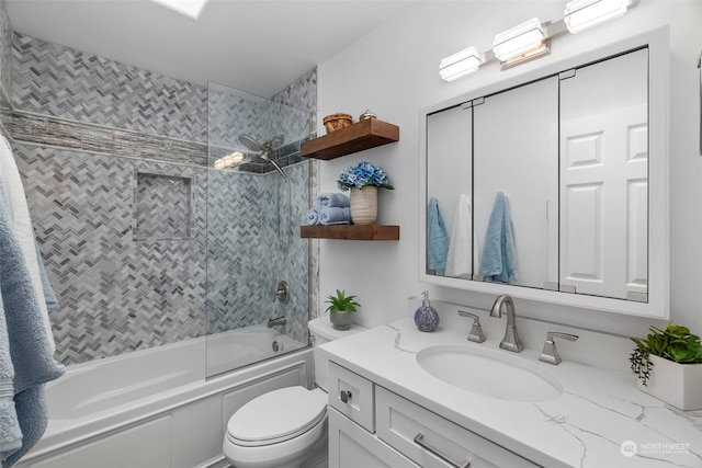 full bathroom featuring vanity, toilet, and tiled shower / bath