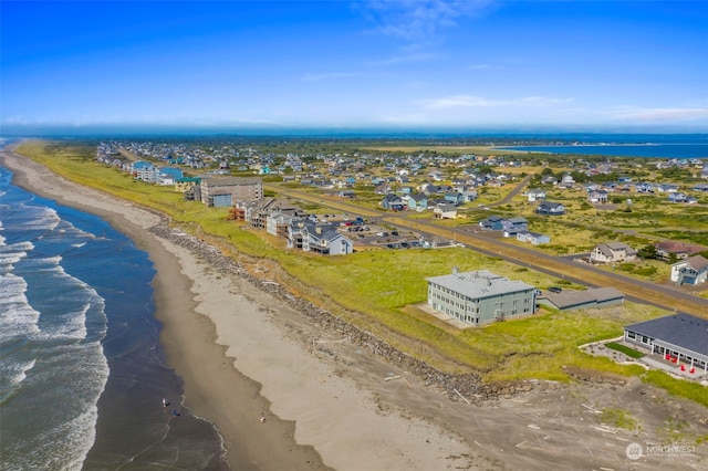 aerial view with a water view and a beach view