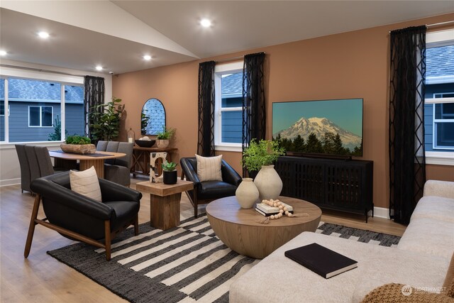 sitting room with light hardwood / wood-style flooring and lofted ceiling