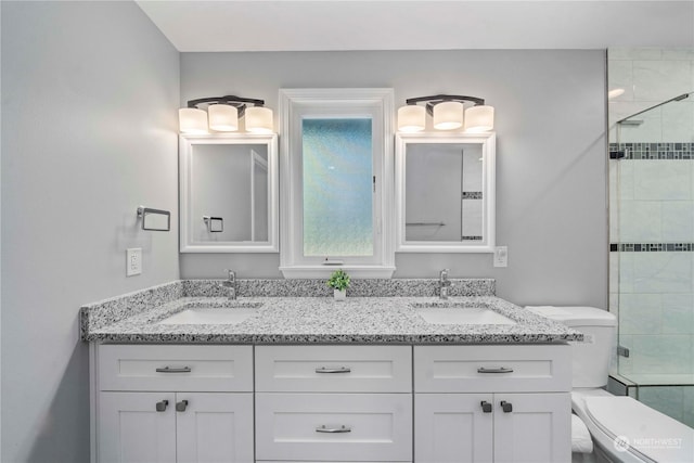 bathroom with walk in shower, vanity, and toilet