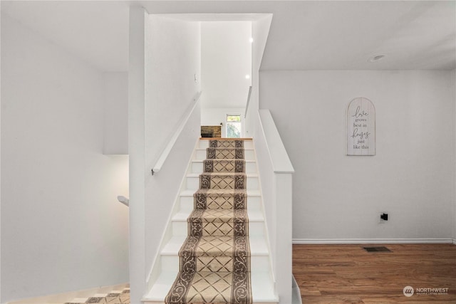 stairway featuring hardwood / wood-style floors