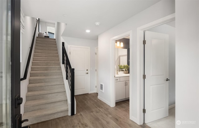 stairs with hardwood / wood-style floors