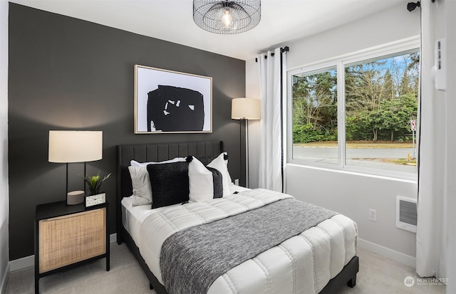 bedroom with light colored carpet and multiple windows